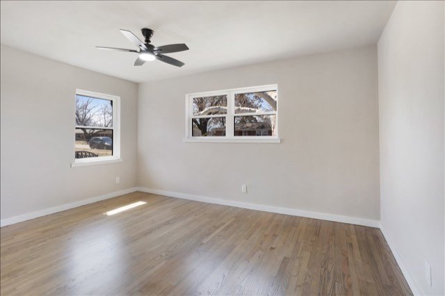 Bright bedroom with new floors and ceiling fan