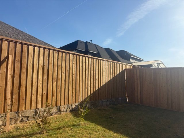 New cedar privacy fence on a stone base