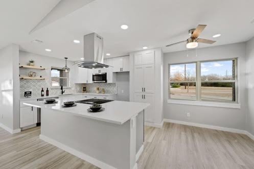 Open kitchen with island and stainless range hood